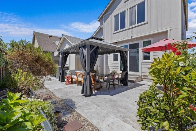 back of house with entry steps, a gazebo, and a patio area