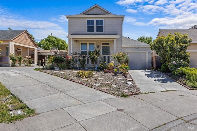 view of front of property featuring an attached garage, concrete driveway, and a porch
