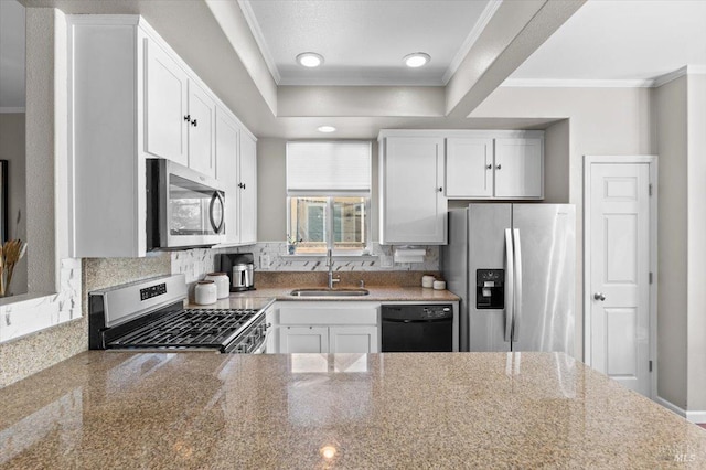 kitchen featuring crown molding, a sink, appliances with stainless steel finishes, and tasteful backsplash