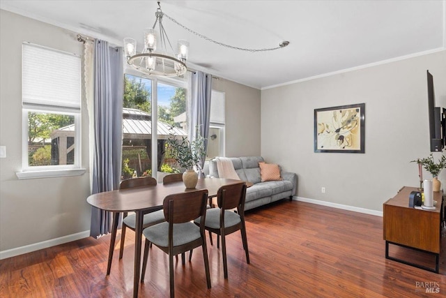 dining space with an inviting chandelier, ornamental molding, baseboards, and dark wood-style flooring
