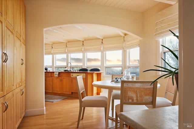 sunroom with a sink and beam ceiling