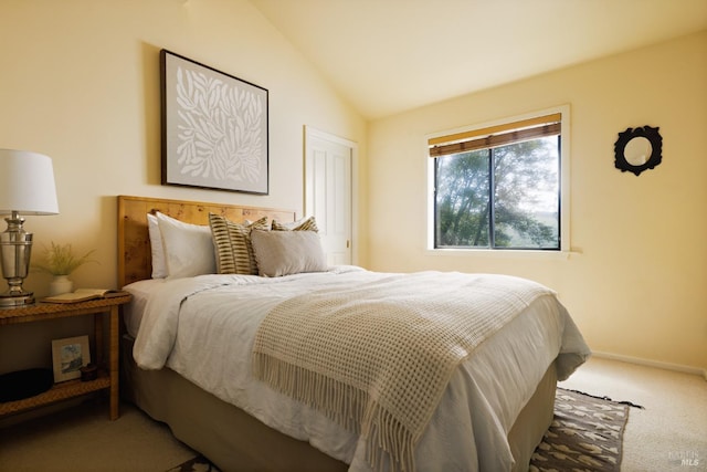 carpeted bedroom with baseboards and lofted ceiling