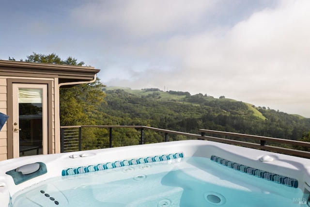 view of swimming pool with a forest view