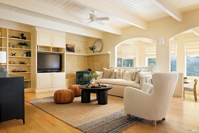living area featuring wood ceiling, ceiling fan, arched walkways, beam ceiling, and light wood-style flooring