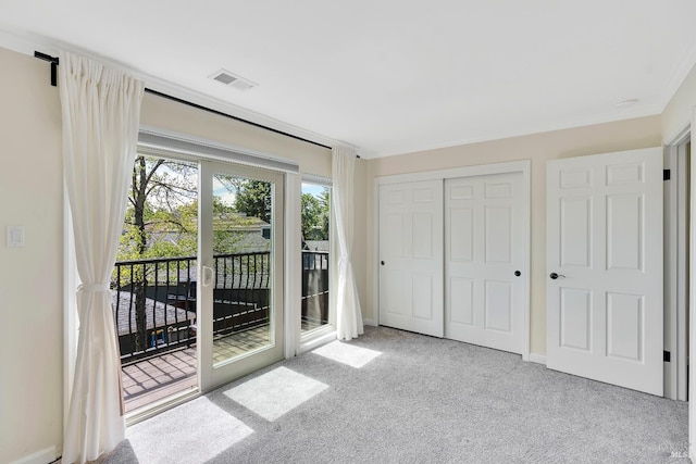 interior space featuring carpet floors, visible vents, access to exterior, and a closet