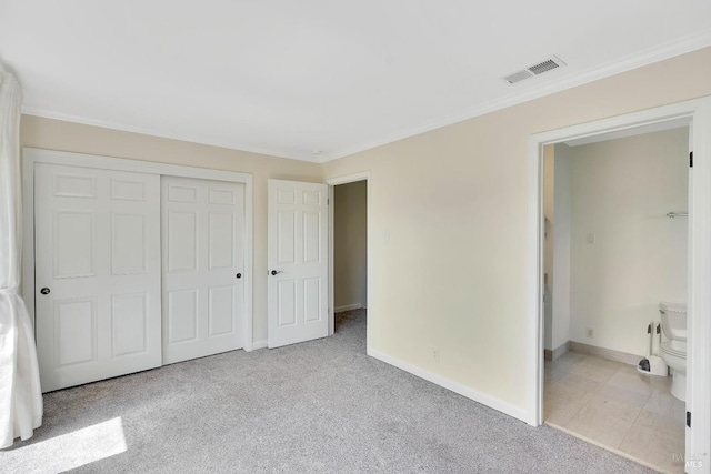 unfurnished bedroom with visible vents, ornamental molding, a closet, light carpet, and baseboards