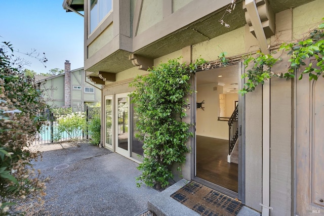 property entrance with stucco siding