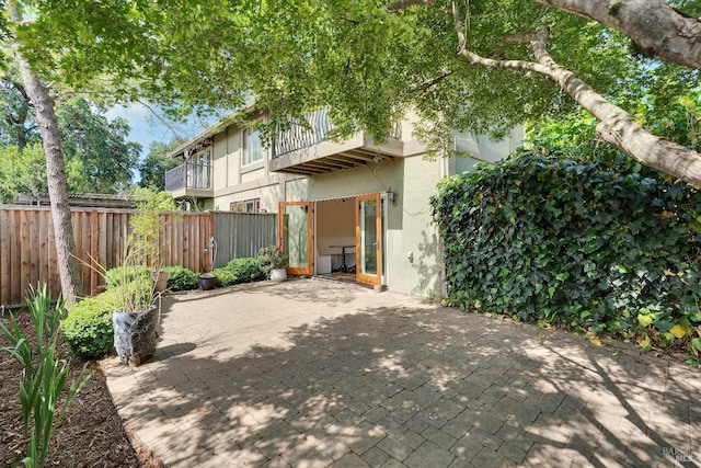 exterior space featuring a fenced backyard, a patio area, and stucco siding