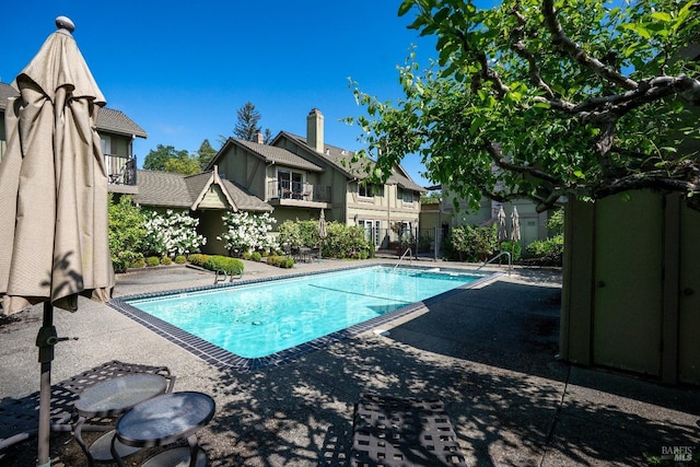 view of pool with a fenced in pool and a patio area