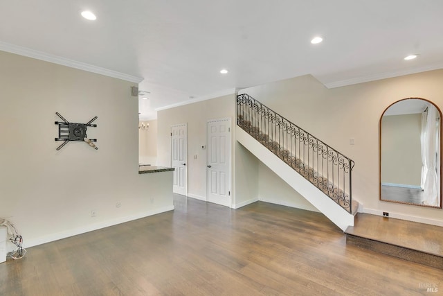 unfurnished living room with crown molding, stairs, and dark wood-style floors