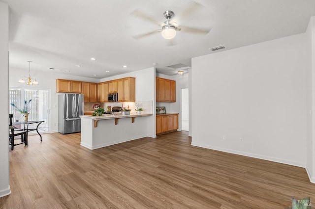943 Bridgeport Way, Rio Vista, CA 94571 - kitchen with appliances with stainless steel finishes, light wood finished floors, a peninsula, and visible vents