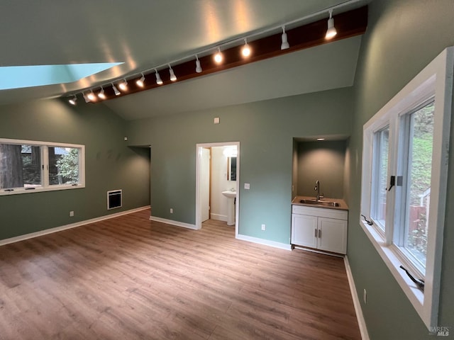 269 Corte Madera Ave, Mill Valley, CA 94941 - unfurnished bedroom with track lighting, a sink, wood finished floors, baseboards, and high vaulted ceiling