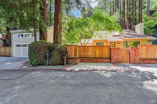 269 Corte Madera Ave, Mill Valley, CA 94941 - view of front facade with a chimney, a fenced front yard, a gate, and an attached garage