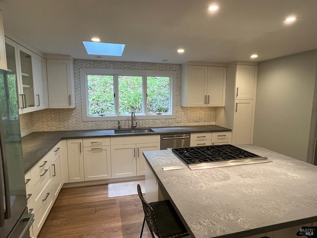 269 Corte Madera Ave, Mill Valley, CA 94941 - kitchen with stainless steel appliances, a sink, wood finished floors, recessed lighting, and white cabinetry