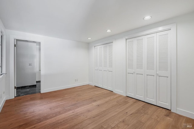 269 Corte Madera Ave, Mill Valley, CA 94941 - unfurnished bedroom featuring two closets, light wood finished floors, recessed lighting, and baseboards