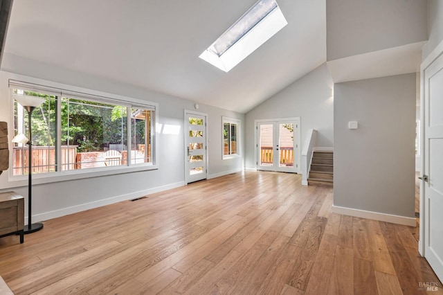 269 Corte Madera Ave, Mill Valley, CA 94941 - unfurnished living room featuring a skylight, light wood-style floors, baseboards, stairway, and high vaulted ceiling