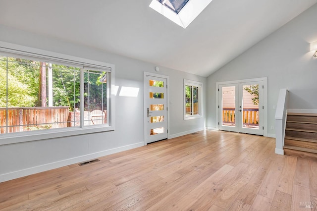 269 Corte Madera Ave, Mill Valley, CA 94941 - unfurnished living room featuring stairway, french doors, light wood-type flooring, baseboards, and a skylight