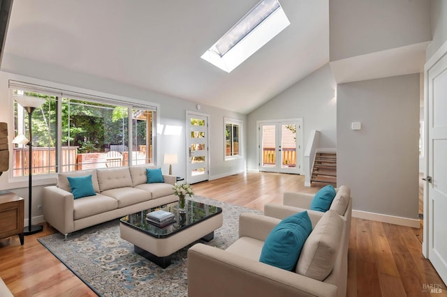 269 Corte Madera Ave, Mill Valley, CA 94941 - living room featuring a skylight, light wood-style floors, baseboards, and high vaulted ceiling