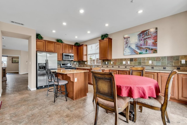 59 Toscana Dr, American Canyon, CA 94503 - kitchen featuring stainless steel appliances, a kitchen island, tasteful backsplash, light countertops, and recessed lighting
