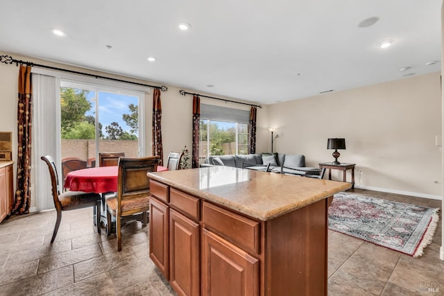 59 Toscana Dr, American Canyon, CA 94503 - kitchen with a kitchen island, open floor plan, recessed lighting, brown cabinets, and stone tile flooring