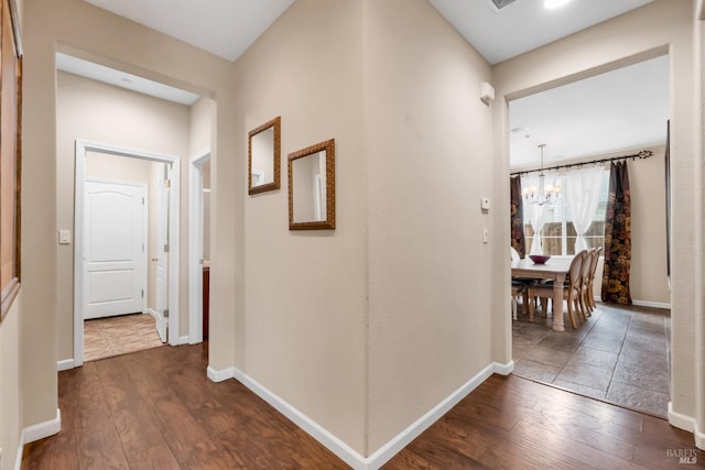 59 Toscana Dr, American Canyon, CA 94503 - hallway with baseboards, dark wood finished floors, and a chandelier
