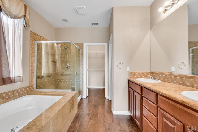 59 Toscana Dr, American Canyon, CA 94503 - bathroom featuring a shower stall, a garden tub, wood finished floors, a spacious closet, and double vanity