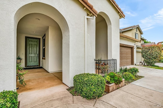 59 Toscana Dr, American Canyon, CA 94503 - doorway to property featuring stucco siding, concrete driveway, and a garage