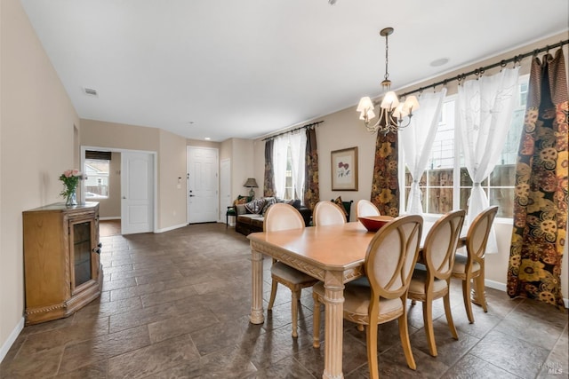 59 Toscana Dr, American Canyon, CA 94503 - dining space with baseboards, a chandelier, and stone tile floors