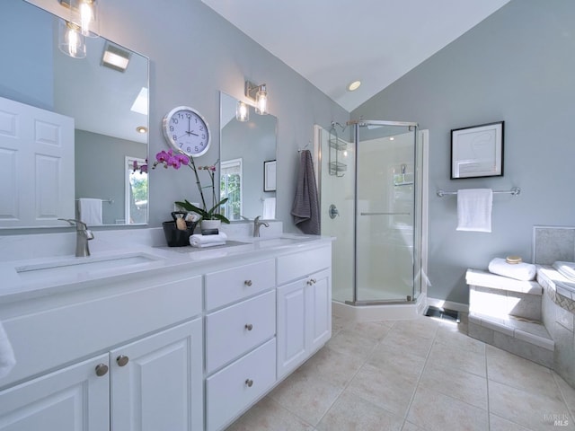 bathroom with vaulted ceiling, tile patterned floors, a stall shower, double vanity, and a bath