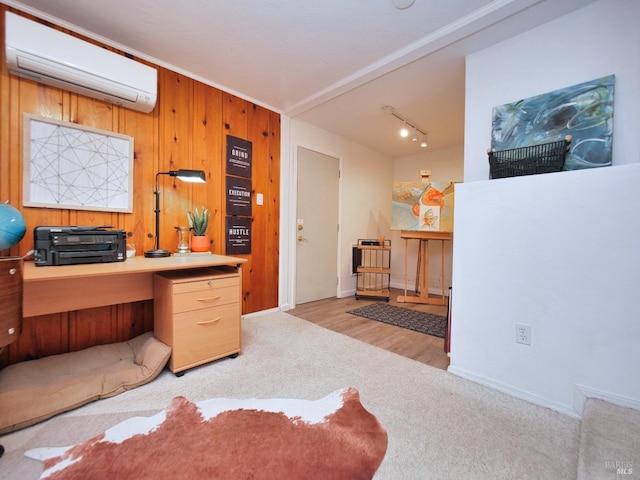 carpeted office space with a wall unit AC, wood walls, and baseboards