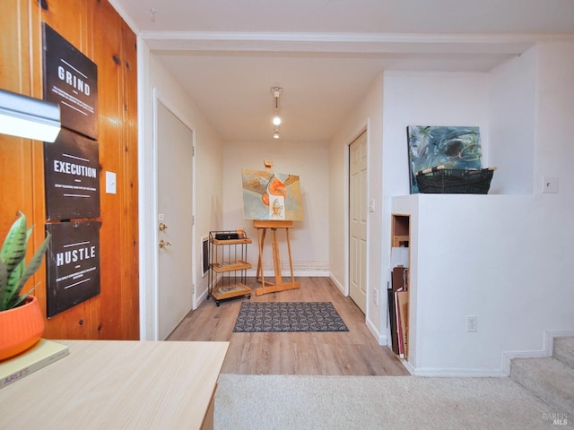 foyer entrance with wood finished floors and baseboards