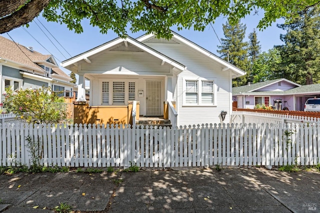 bungalow-style home with a fenced front yard