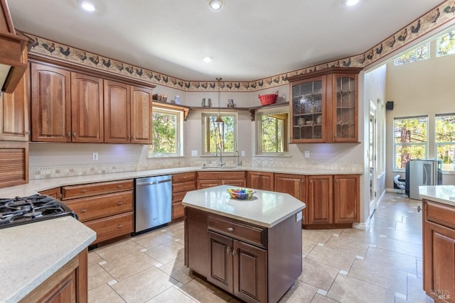 35600 Rock Creek Rd, Shingletown, CA 96088 - kitchen featuring stainless steel dishwasher, glass insert cabinets, a sink, and light countertops