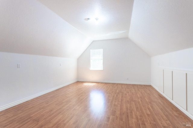 35600 Rock Creek Rd, Shingletown, CA 96088 - bonus room featuring baseboards, light wood finished floors, and lofted ceiling