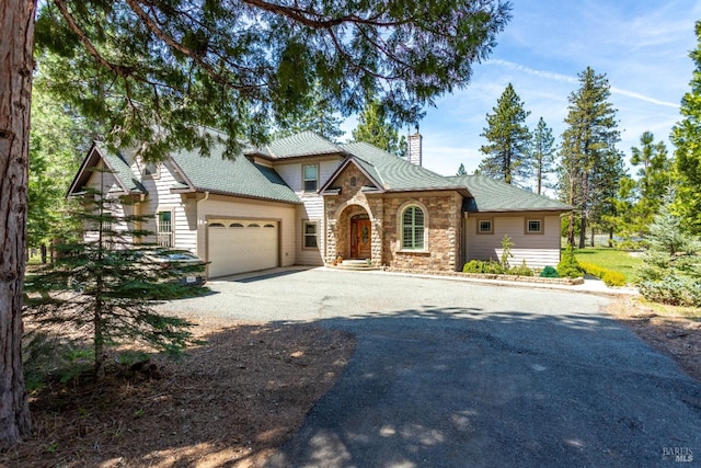 35600 Rock Creek Rd, Shingletown, CA 96088 - craftsman inspired home featuring a chimney, a garage, driveway, and stone siding