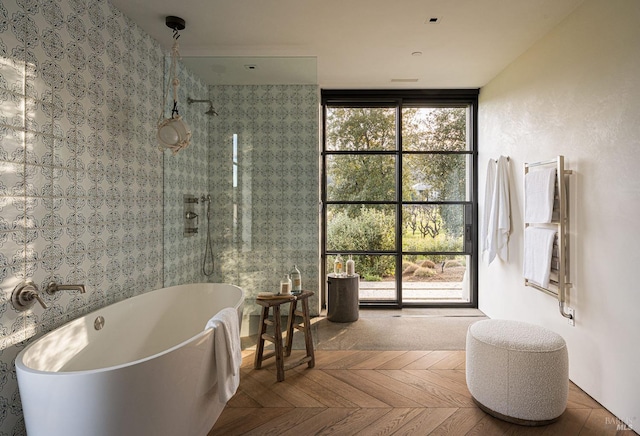 bathroom with a tile shower and a soaking tub