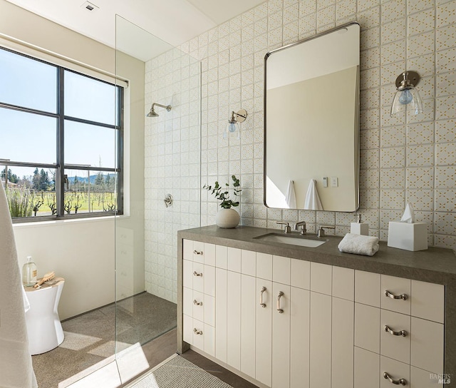 bathroom with walk in shower, tile walls, and a healthy amount of sunlight