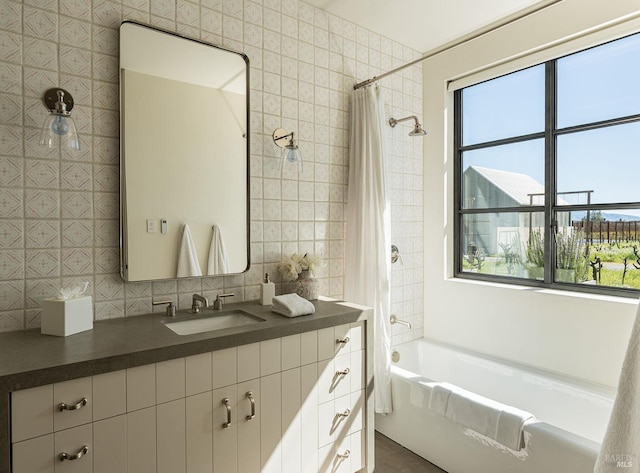 full bath with vanity, decorative backsplash, shower / tub combo with curtain, and tile walls