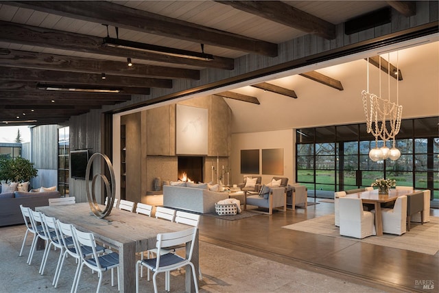 dining space featuring beamed ceiling, a chandelier, wooden ceiling, and a wealth of natural light