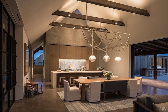 dining room featuring high vaulted ceiling, beamed ceiling, and concrete flooring