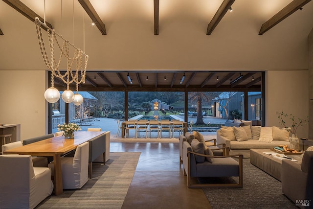 living room featuring a high ceiling, beam ceiling, and finished concrete floors