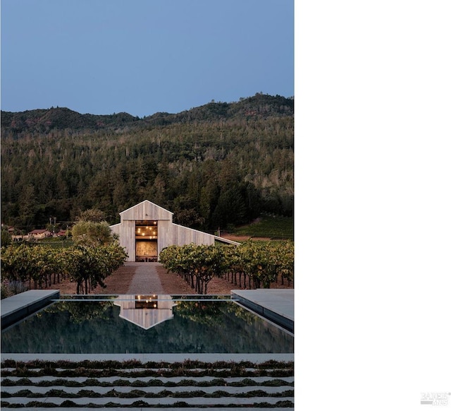 exterior space with a mountain view and a wooded view