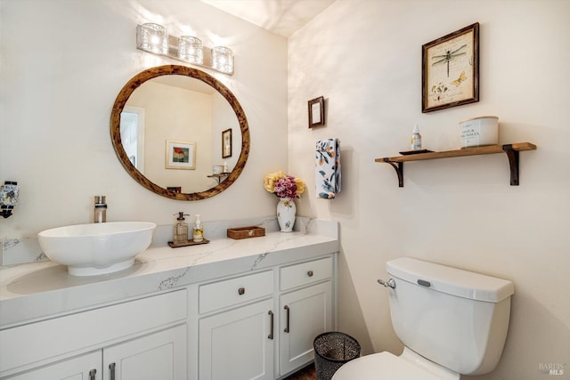 bathroom featuring vanity and toilet