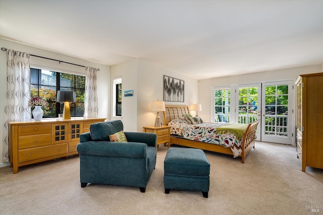 bedroom featuring access to outside, light carpet, and multiple windows
