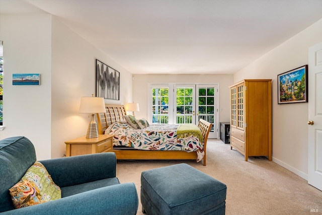 bedroom with baseboards and light carpet