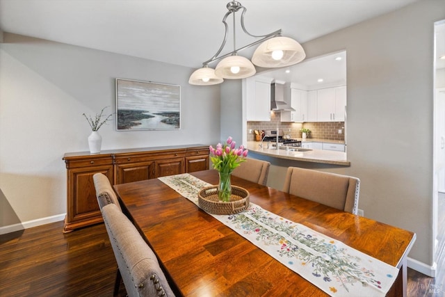 dining space featuring baseboards, dark wood-type flooring, and recessed lighting