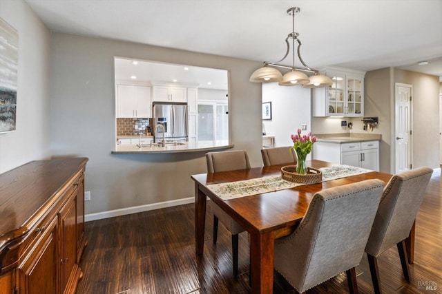 dining room with dark wood-type flooring, baseboards, and recessed lighting