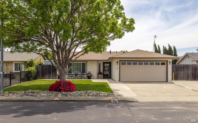 single story home with a garage, stucco siding, fence, concrete driveway, and a front yard