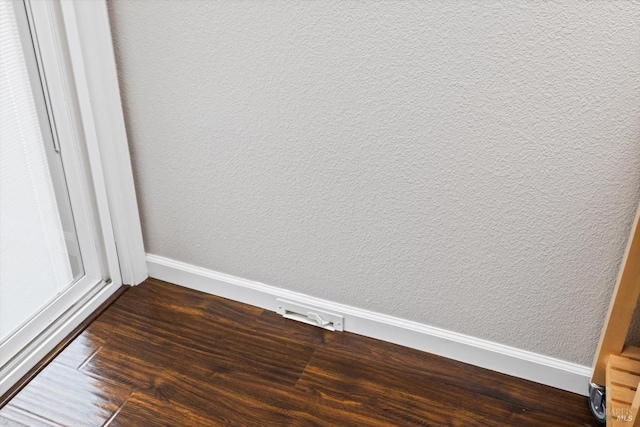 interior details with baseboards and wood finished floors