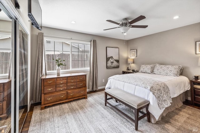 bedroom featuring a ceiling fan, wood finished floors, baseboards, and recessed lighting